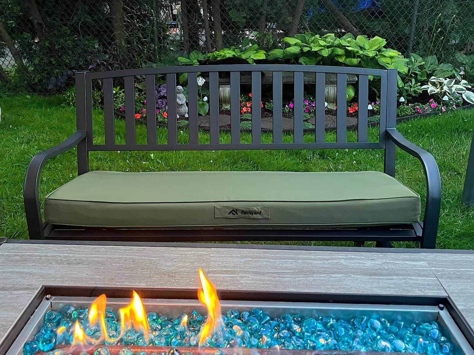 Favoyard Outdoor bench green cushion in a gardenforeground.
