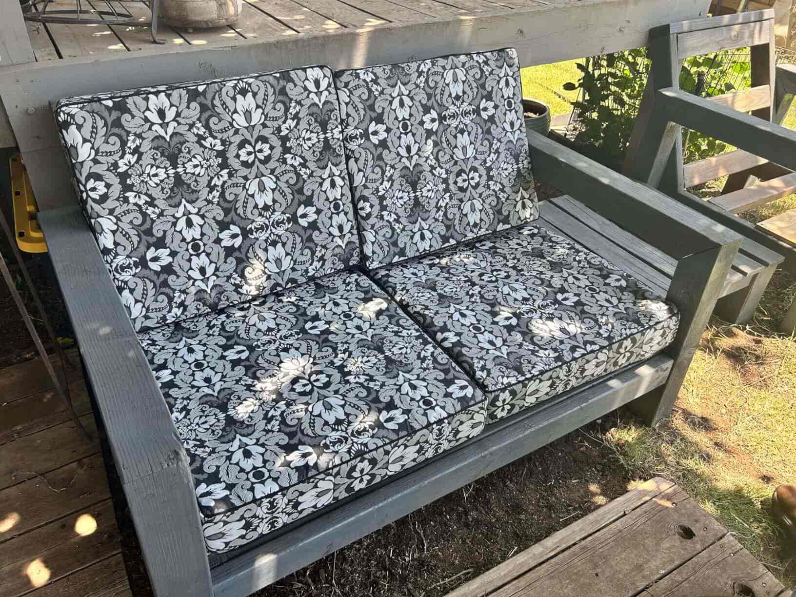 Outdoor bench with floral patterned cushions with Favoyard