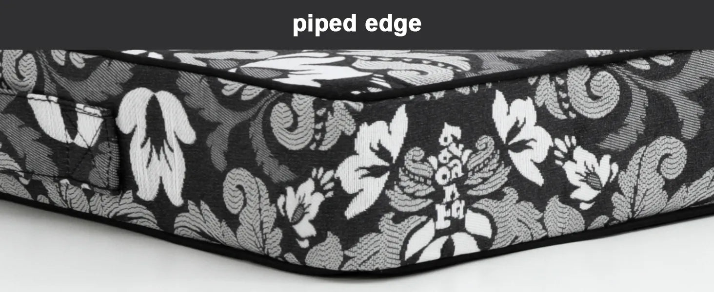 Floral patterned mattress with piped edge of Favoyard lounge chair cushion