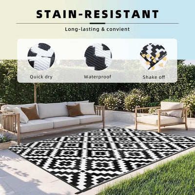 Outdoor patio with a black and white patterned Favoyard outdoor rug