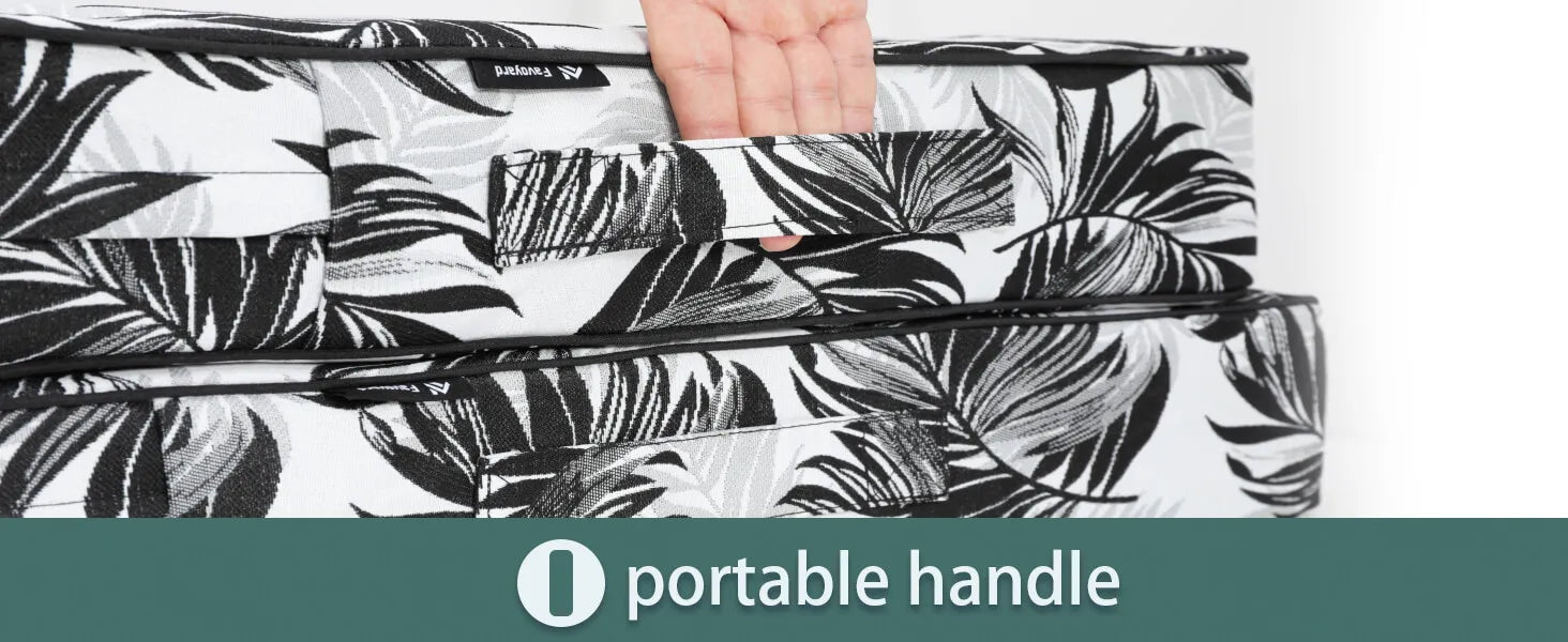 Black and white floral-patterned outdoor cushion with a portable handle 